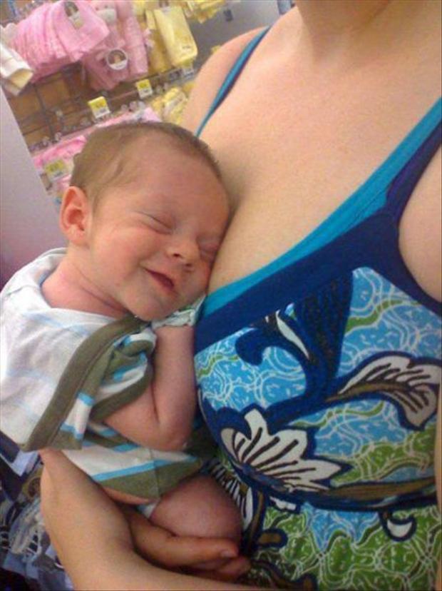 kid sleeping on moms breasts