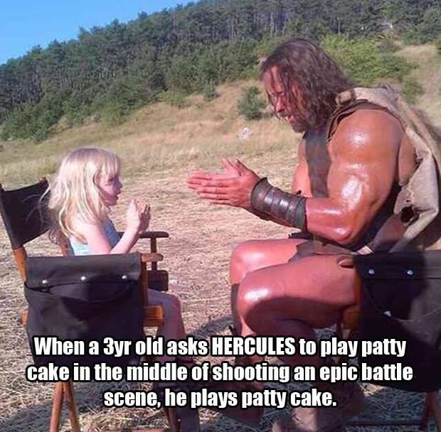a rock and little girl playing patty cake