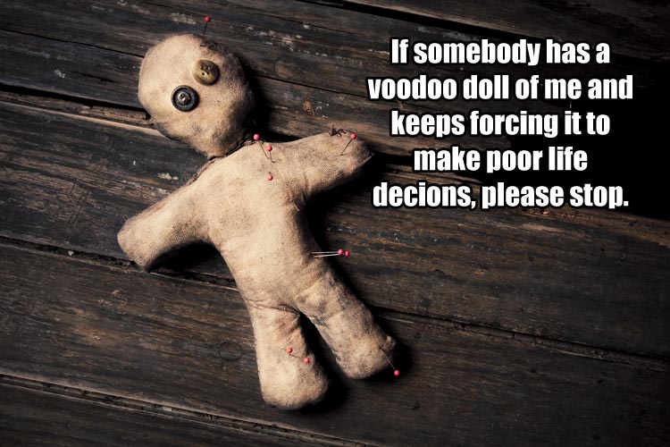 creepy voodoo doll on wooden floor